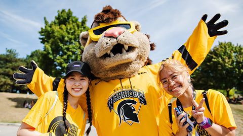 Two students pose with King Warrior